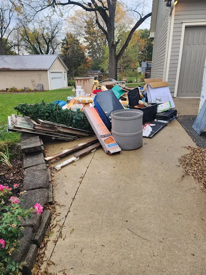 Dumpster being loaded with debris for Estate Cleanout Dumpster Rental in West Liberty